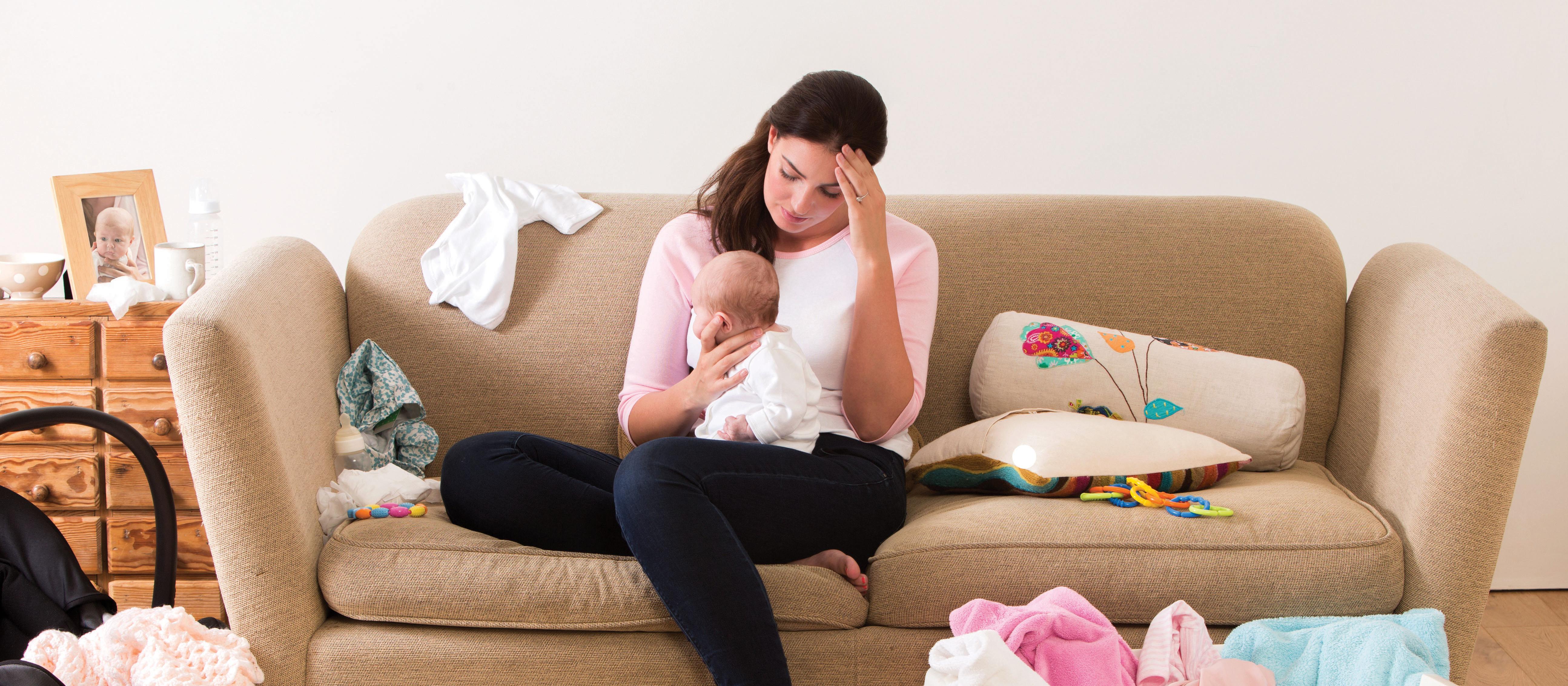 Tired mother with newborn baby