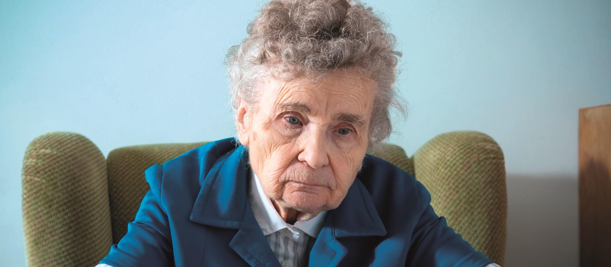 Elderly woman with pills