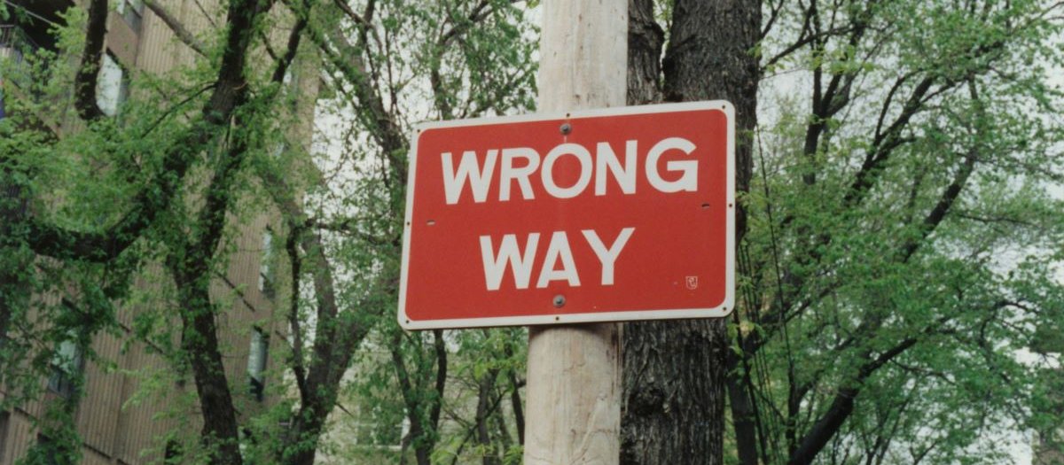 Wrong way sign CR Randy Laybourne on Unsplash