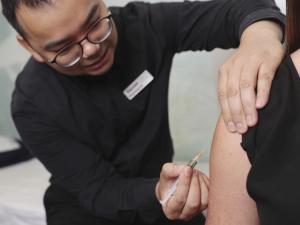 Anglesea Pharmacy dispensary manager Steven Chang gives intern pharmacist Lauren Cutler an MMR vaccination