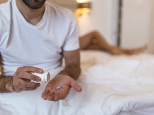 man holding pill