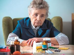 Elderly woman with pills